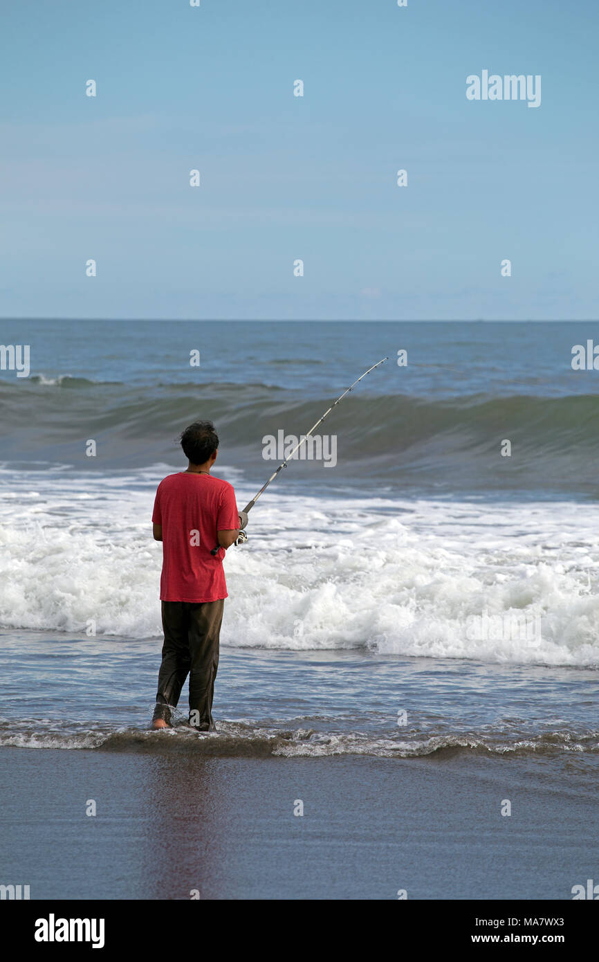 Man fishing on an asian beach Stock Photo
