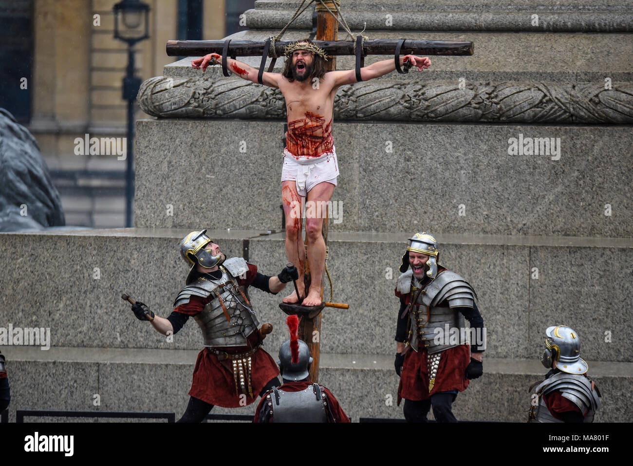 Wintershall CIO portrayed Passion and the resurrection of Jesus Christ using Trafalgar Square. Christ being nailed to the cross. Laughing Roman Stock Photo