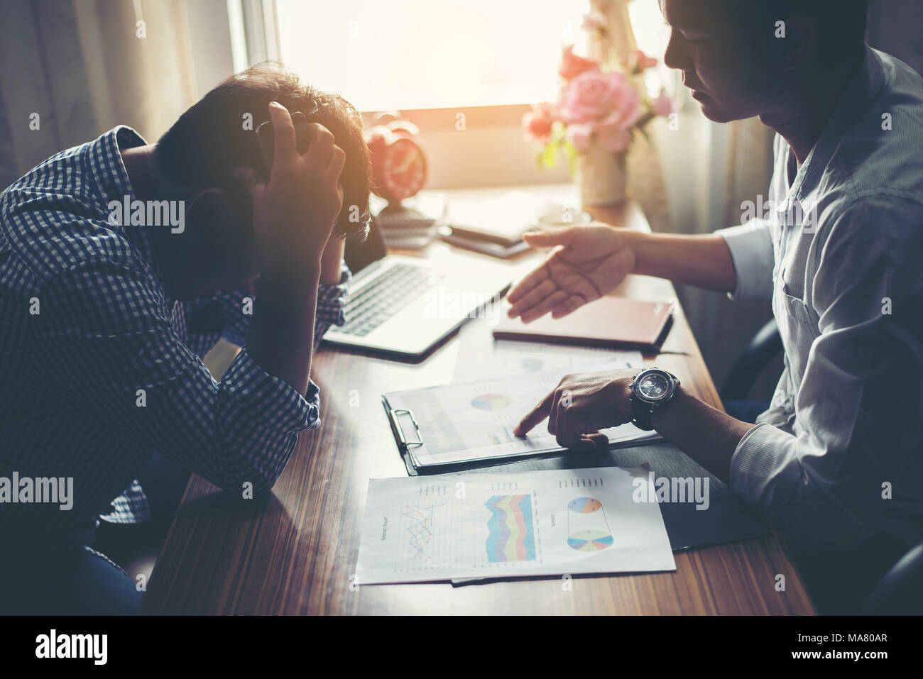Two employees sitting desk hi-res stock photography and images - Alamy