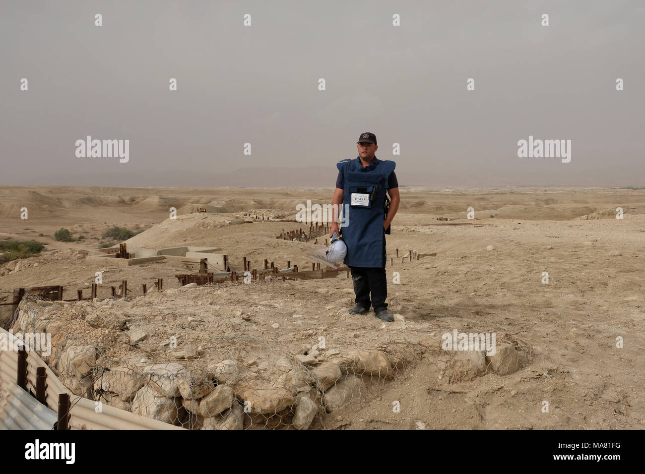 Qaser el Yahud, Israel 29th March 2018. Operations and Logistics Officer of HALO Trust group Hagai Golibrozky stands over a deserted military position in 'The land of Monasteries' area near the baptismal site Qaser el Yahud traditional site of the baptism of Jesus by John the Baptist in the Jordan River Valley region of West Bank, Israel. The area started to be cleared of some 4,000 landmines from the 1967 war and its aftermath by HALO Trust, a Scottish demining group that operates in 19 places around the world. Stock Photo