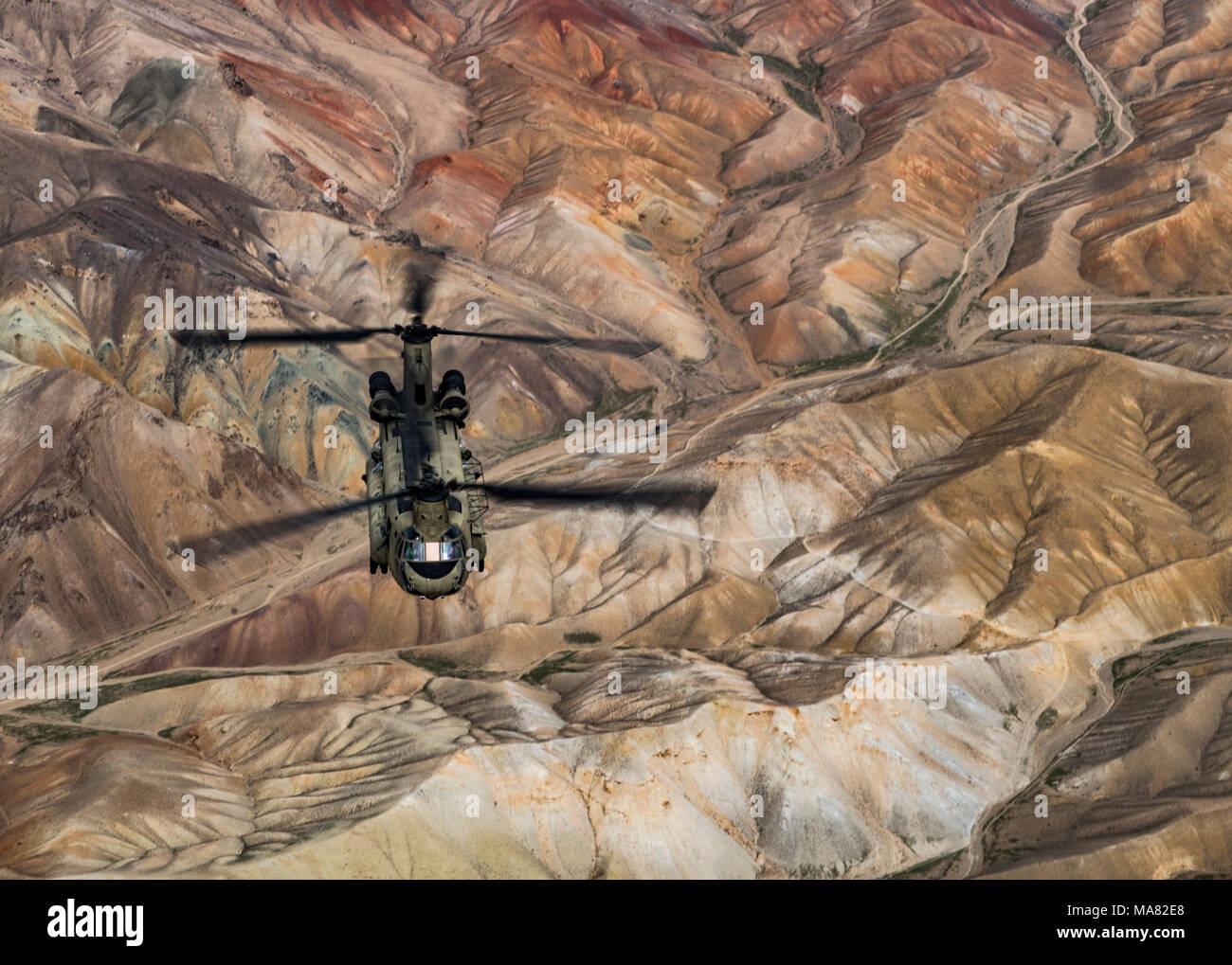 A U.S. Army Task Force Brawler CH-47F Chinook flies while conducting a training exercise with a Guardian Angel team assigned to the 83rd Expeditionary Rescue Squadron at Bagram Airfield, Afghanistan, March 26, 2018. The Army crews and Air Force Guardian Angel teams conducted the exercise to build teamwork and procedures as they provide joint personnel recovery capability, aiding in the delivery of decisive airpower for U.S. Central Command. (U.S. Air Force Photo by Tech. Sgt. Gregory Brook) Stock Photo