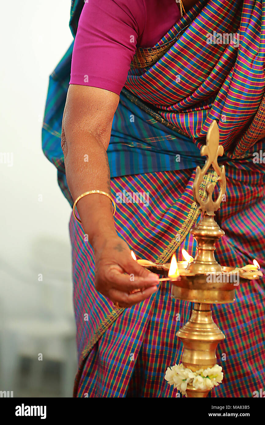 Traditional south Indian brass oil lamp with people Stock Photo - Alamy