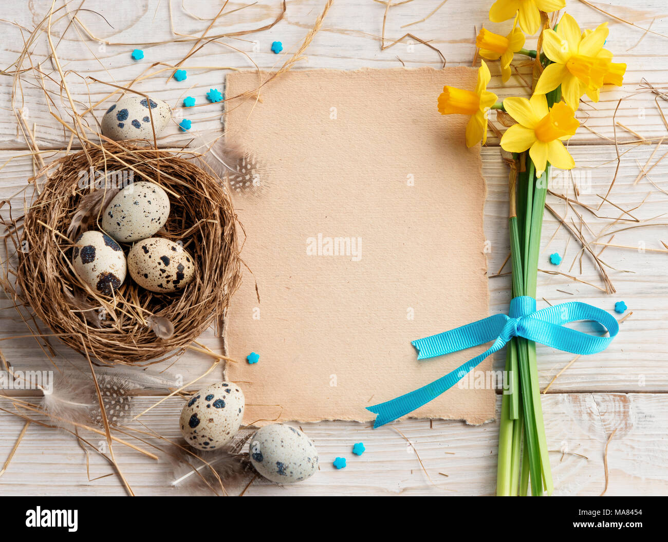 Easter background with Easter eggs and spring flowers. Top view with copy space. Stock Photo