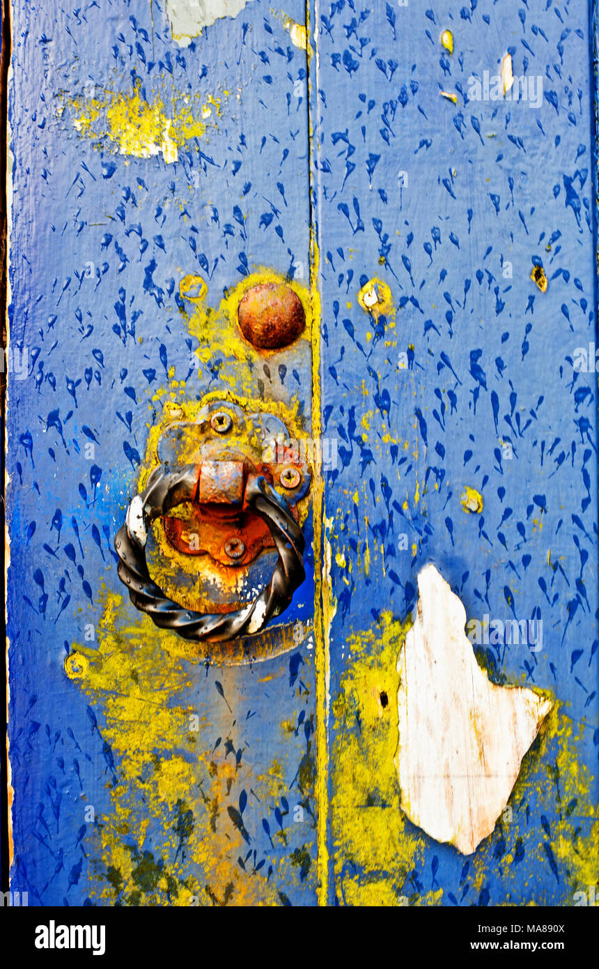 Blue and Yellow flaking  paint on wood door Stock Photo
