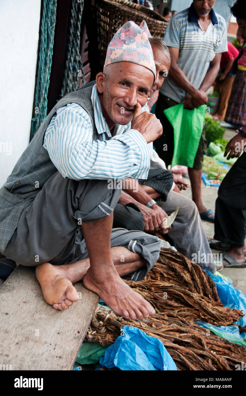 Nepal 2014. Manibanjan. Market day. Men selling raw tobacco. Stock Photo