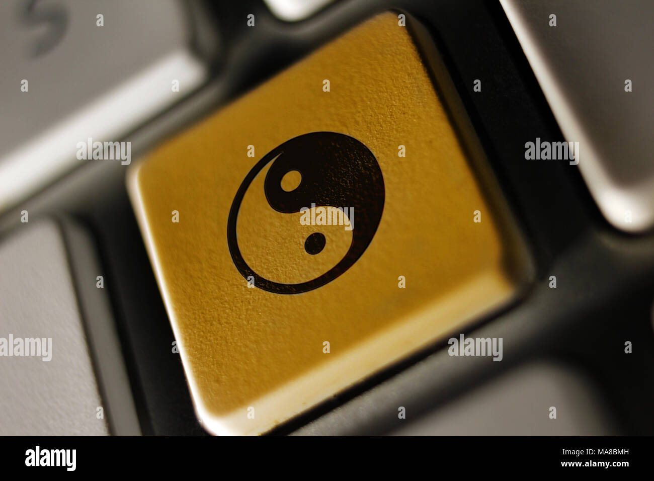 Image of ying-yang icon on computer keyboard Stock Photo