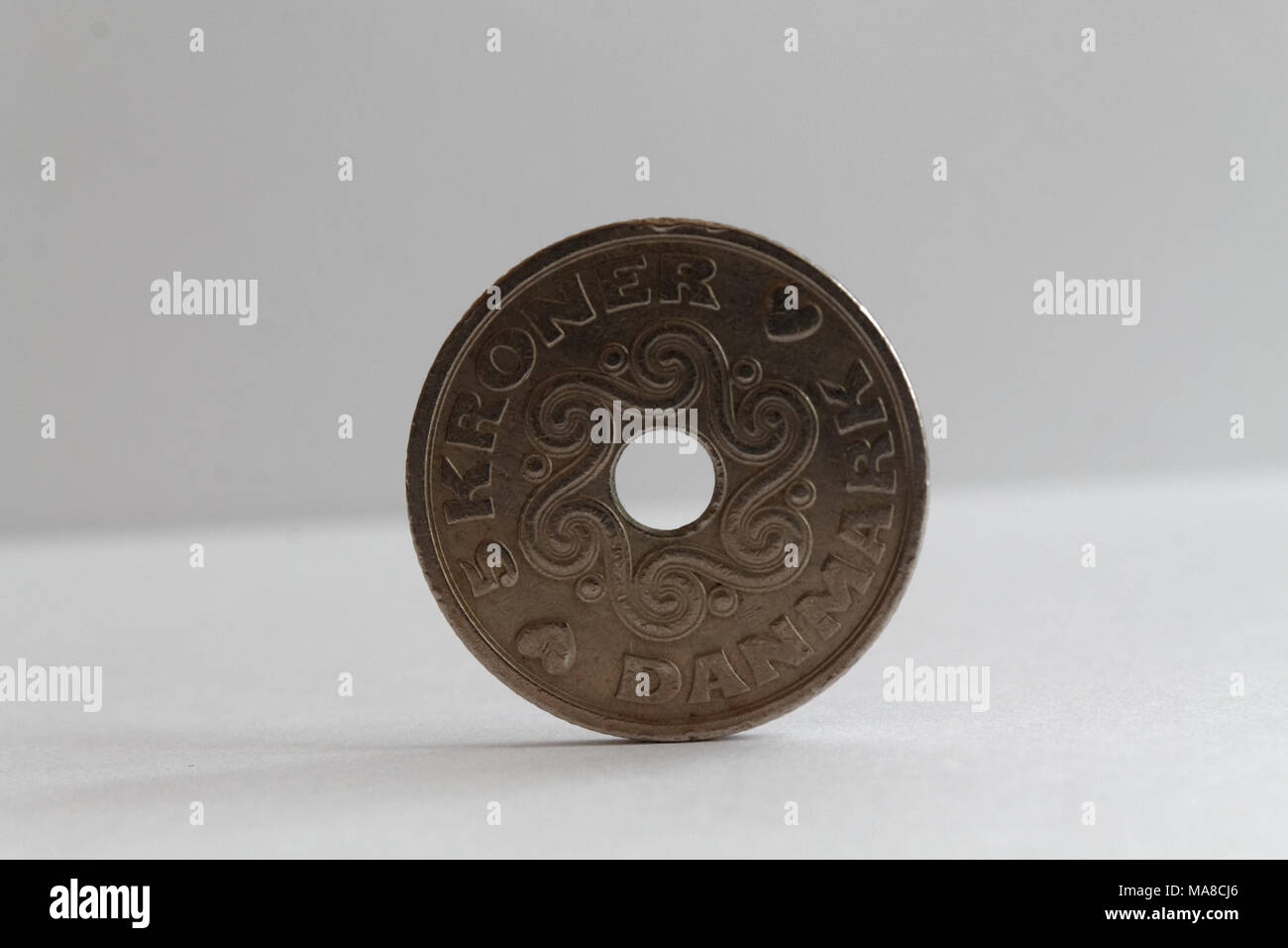 One Denmark coin lie on isolated white background Denomination is five krone (crown) - back side Stock Photo