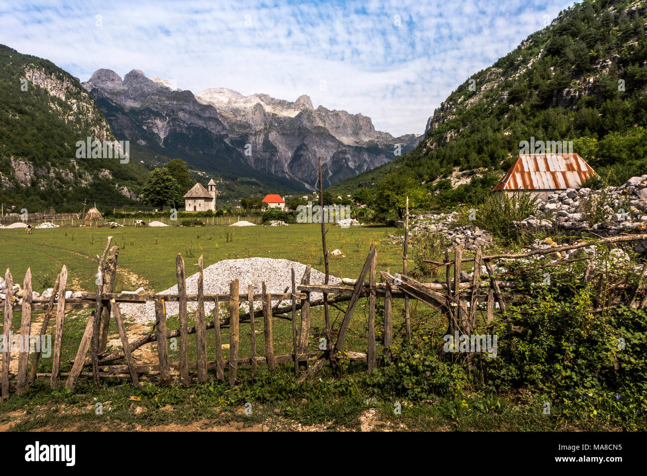 Scenic Theth mountain village panorama with an old wooden picket fence and an ancient church, northern Shkodra region, Albania Stock Photo