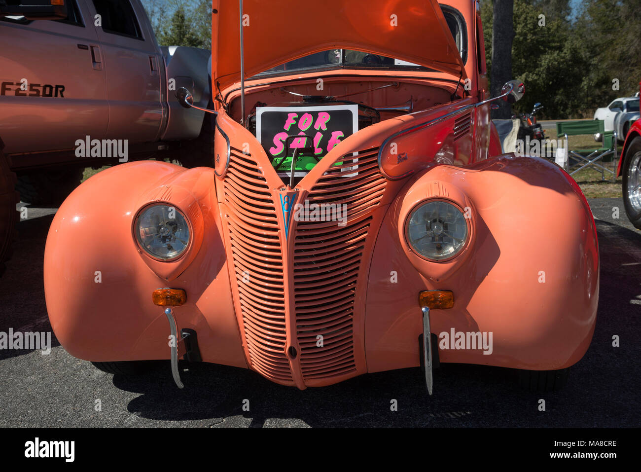 Car Show in Ft. White, Florida. 1939 bright orange Ford sedan with V8 engine Stock Photo