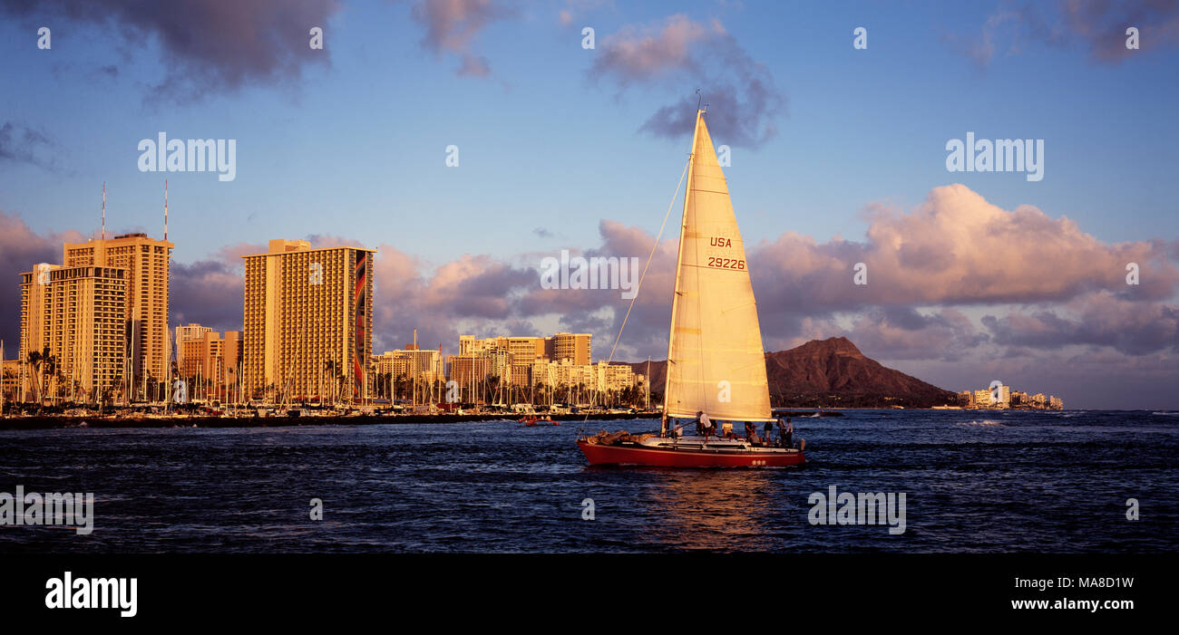Side view of yacht with panoramic view of Waikiki, Honolulu, Hawaii. Stock Photo