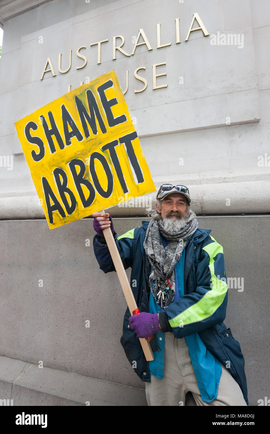 A man holds a placard  'Shame Abbott' (Australian PM Tony Abbott,) at protest at Australia House, London demanding an end to forced closure of Aborigine Communities. Stock Photo