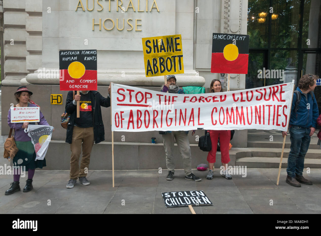 Protesters with banner and placards in front of Australia House, London demanding an end to forced closure of Aborigine Communities. Stock Photo