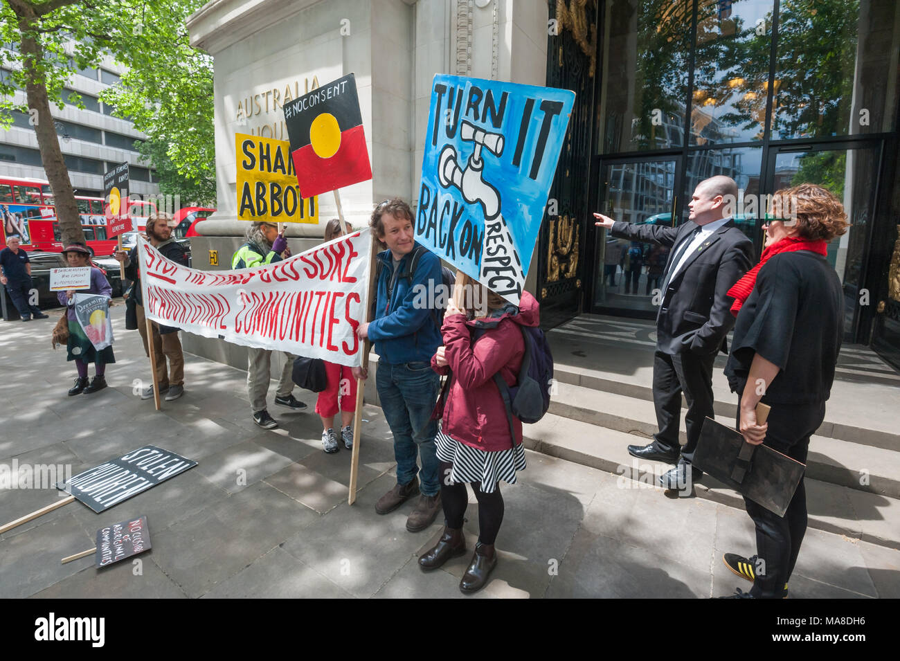 A man from Australia House tells protesters  demanding an end to forced closure of Aborigine Communities that they must keep away from the building. Stock Photo