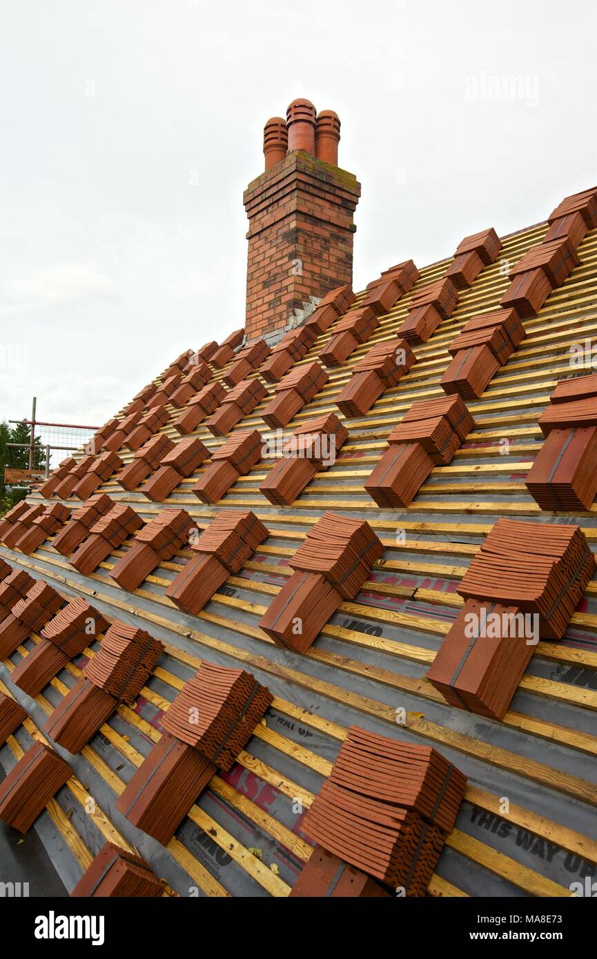 Part of Set of pictures showing original disrepair, then renovation of tiled roof, gutters etc on 1900's brick house in Shropshire UK Stock Photo