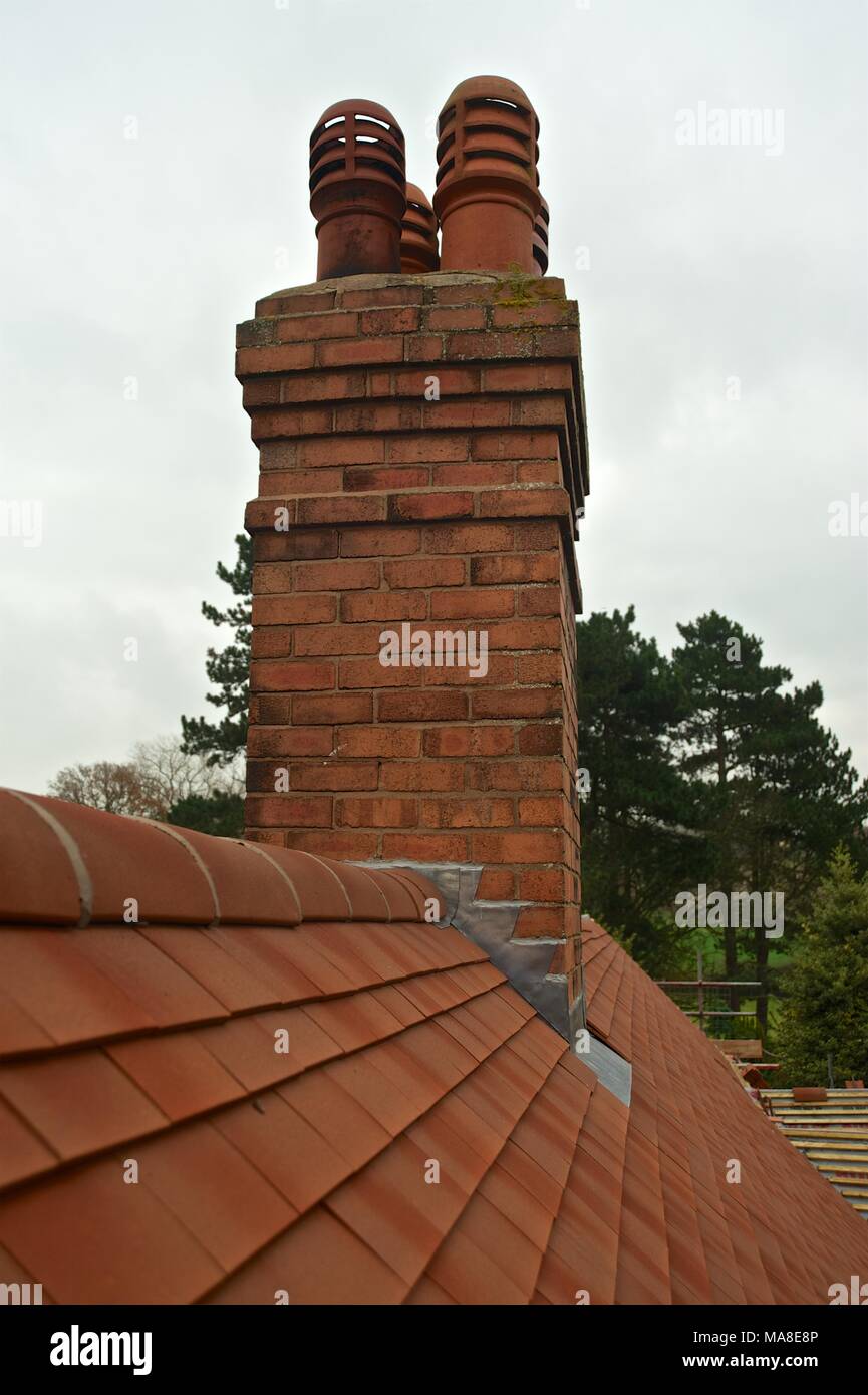 Part of Set of pictures showing original disrepair, then renovation of tiled roof, gutters etc on 1900's brick house in Shropshire UK Stock Photo