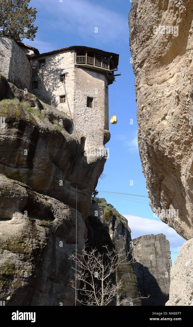 The cargo is elevate to the monastery on a rock in Meteora by a rope, Greece. Stock Photo