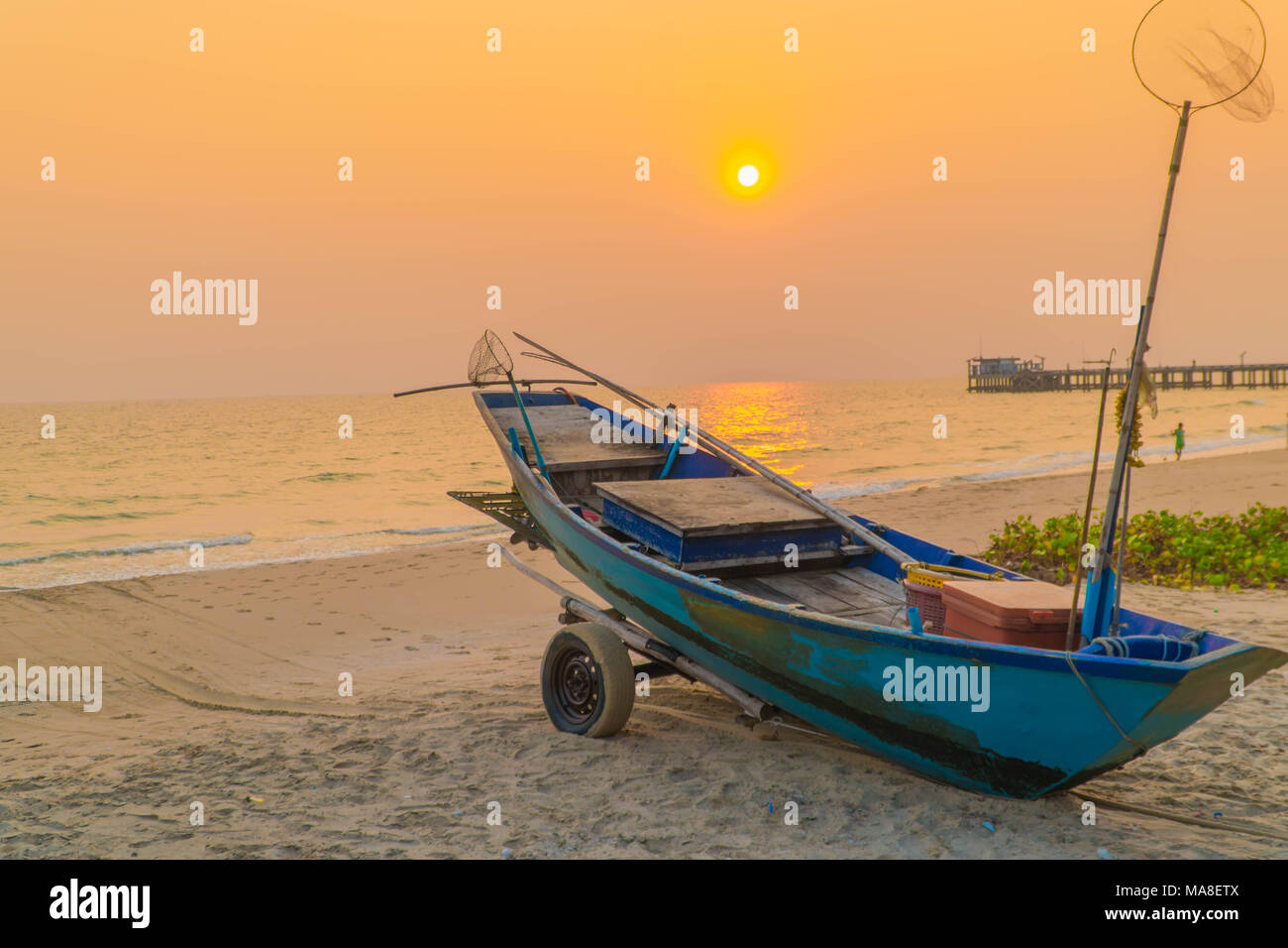 Sunset at anchor fishing boat at low tide Stock Photo - Alamy
