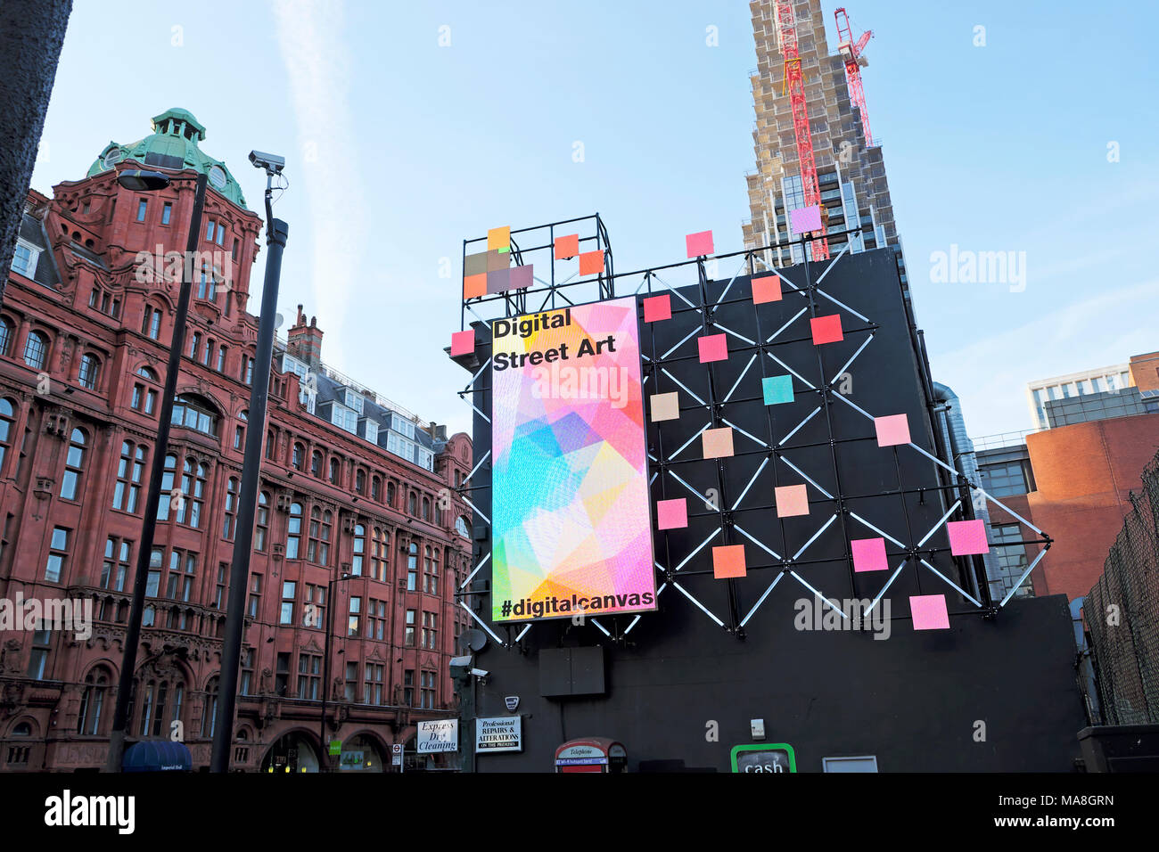 Digital Street Art electronic billboard and poster on side of building corner of Old Street and City Road in Shoreditch East London UK  KATHY DEWITT Stock Photo