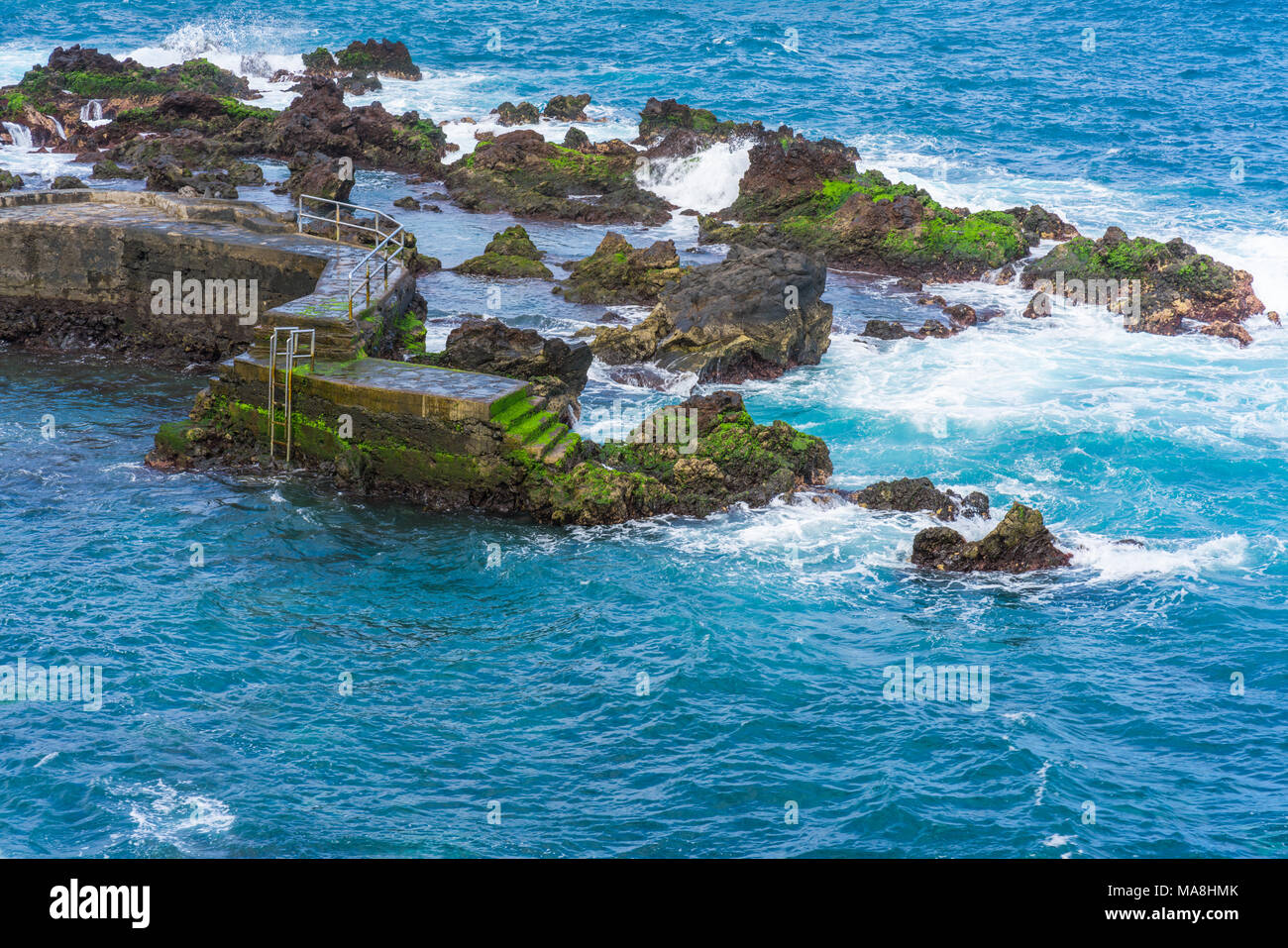 View of sea and waves crashing against harbour in Puerto de la Cruze, Tenerife, Canary Islands Stock Photo