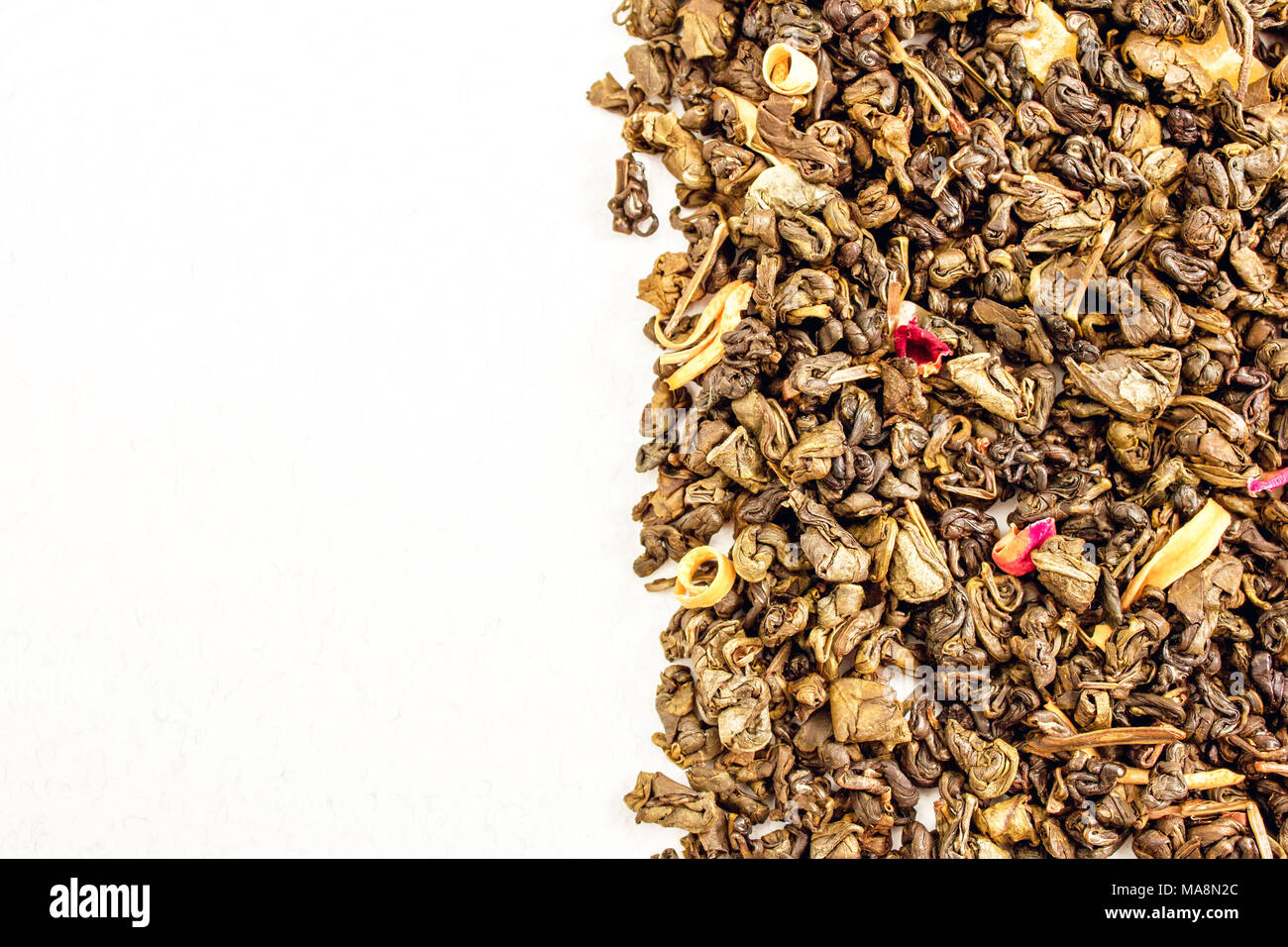 tea leaves, with rose and mango on white background Stock Photo