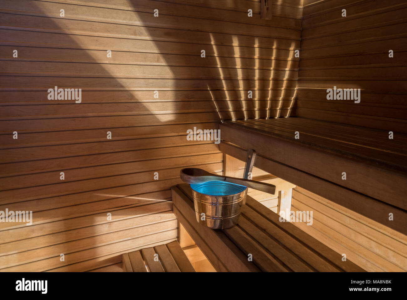 Wellness and spa conception. Sauna bath bucket with blue water, scoop