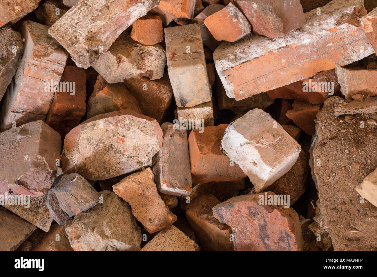 Brick background pattern. Pile of red stones. Stock Photo