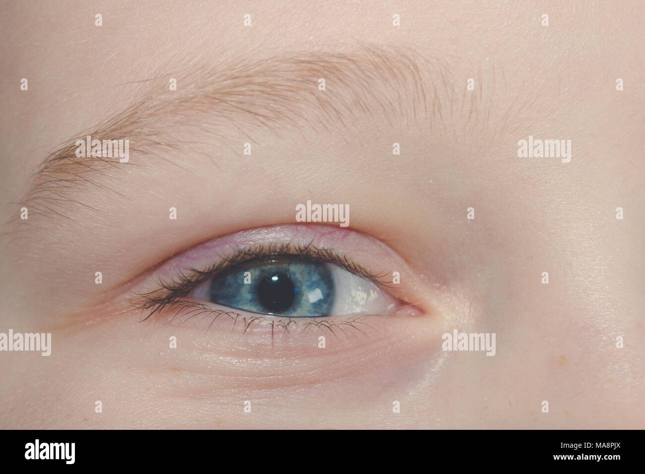Baby blue beautiful, brooding eyes of a boy Stock Photo - Alamy