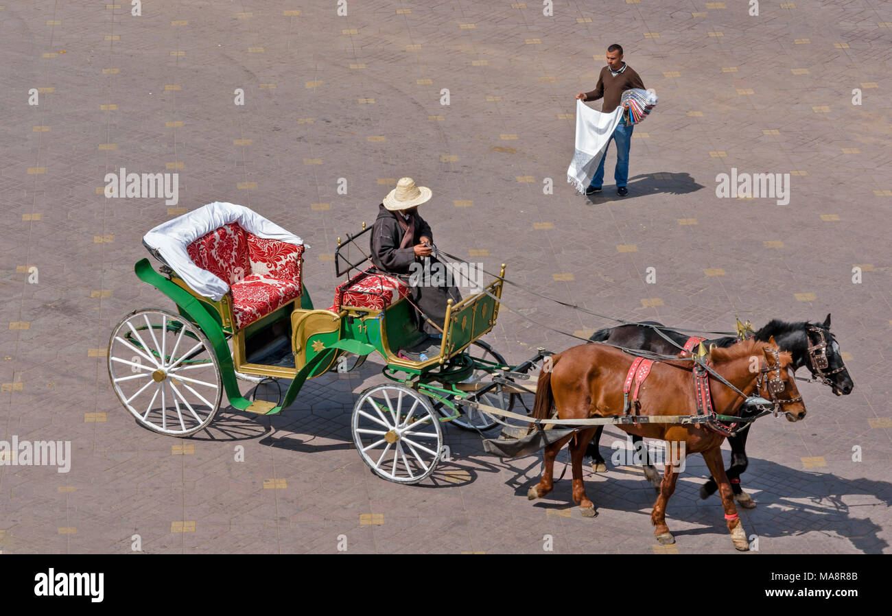 MOROCCO MARRAKECH PLACE JEMAA EL FNA TWO HORSES AND A CARRIAGE FOR TOURISTS Stock Photo