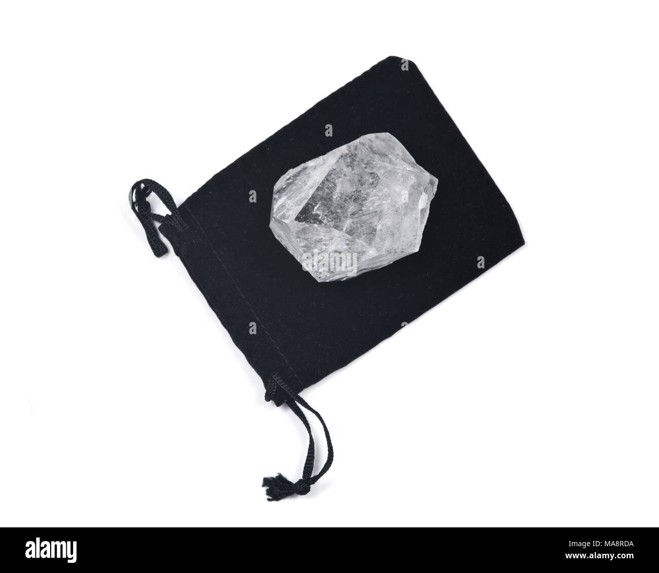 Clear quartz cathedral point on black velveteen crystal pouch isolated