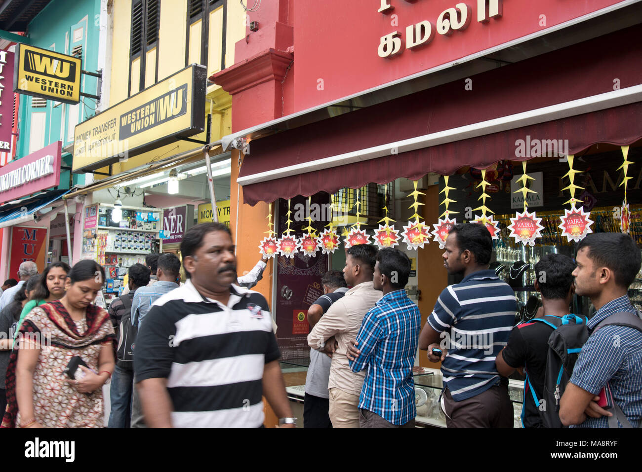 Migrant workers in line outside Western Union office to send remittances  back to their home countries in Singapore Stock Photo - Alamy
