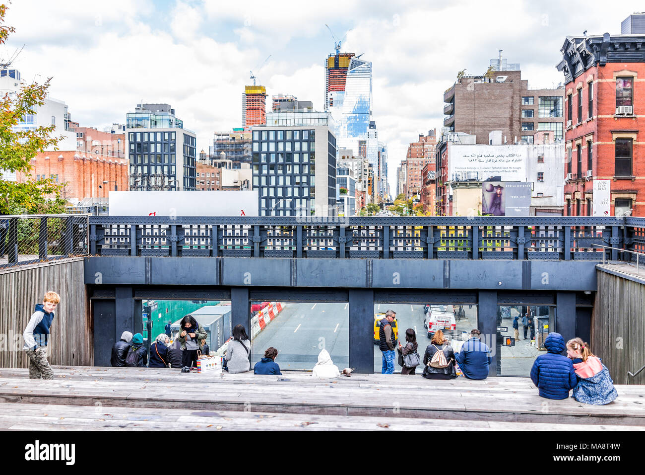 New York City, USA - October 30, 2017: Highline, high line, urban garden in NYC with many people tourists, sitting in Chelsea West Side by Hudson Yard Stock Photo