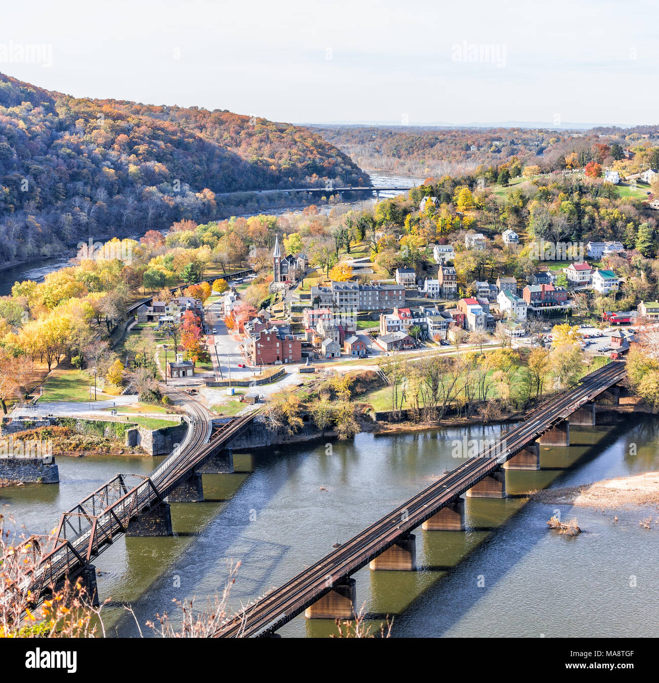 Harper's Ferry overlook with colorful orange yellow foliage fall autumn forest with small village town by river in West Virginia, WV Stock Photo