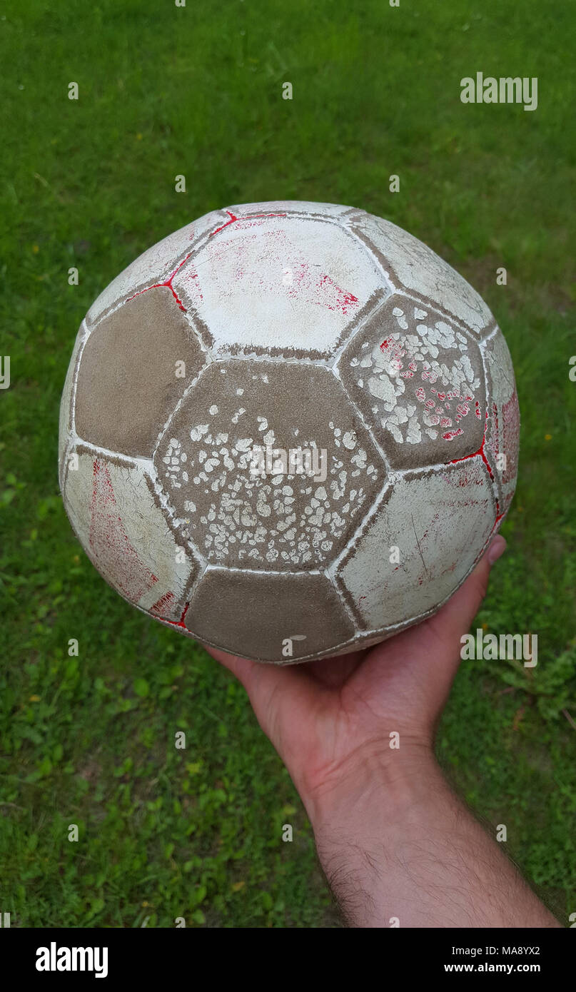 Soccer ball in hand Stock Photo Alamy