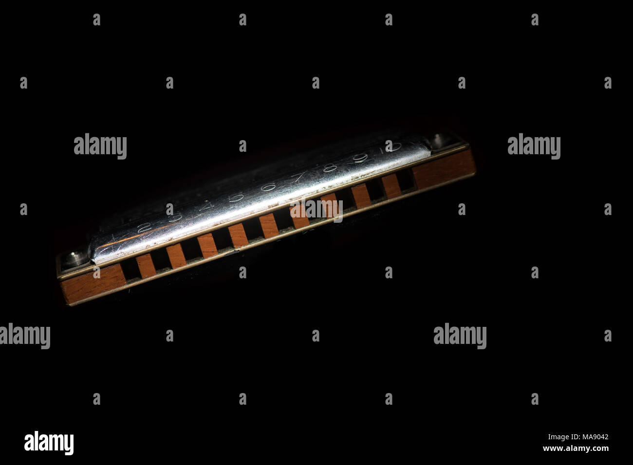 Mouth harmonica country blues on a black background. Stock Photo