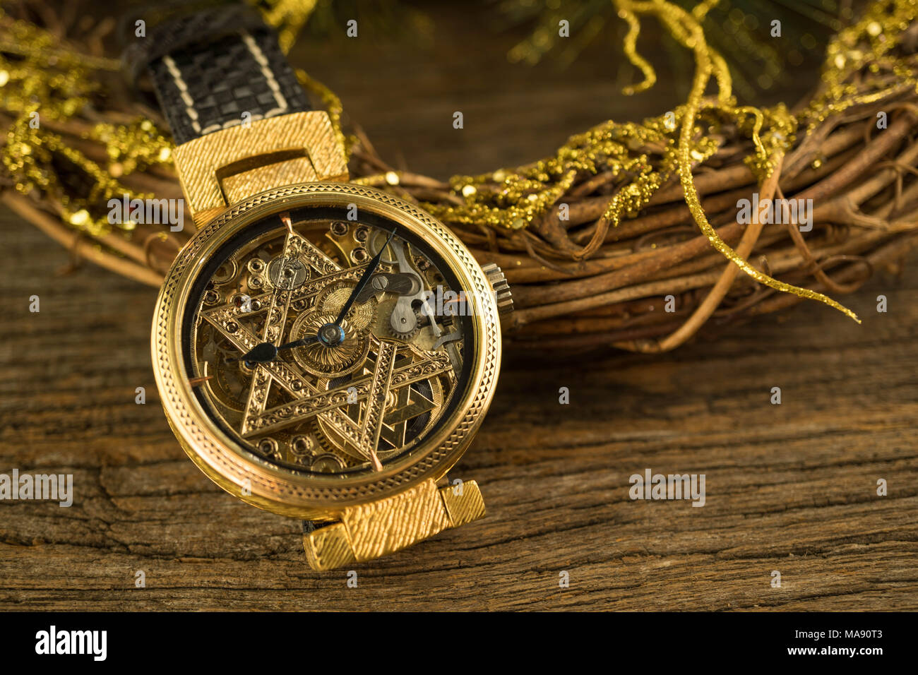 Vintage skeleton watch with Star of David on wood background Stock Photo