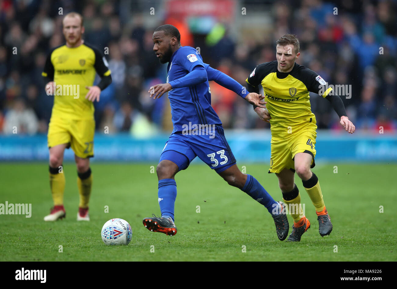 Cardiff City's Junior Hoilett and Burton Albion's Jamie Allen battle for the ball during the Sky Bet Championship match at the Cardiff City Stadium. Stock Photo