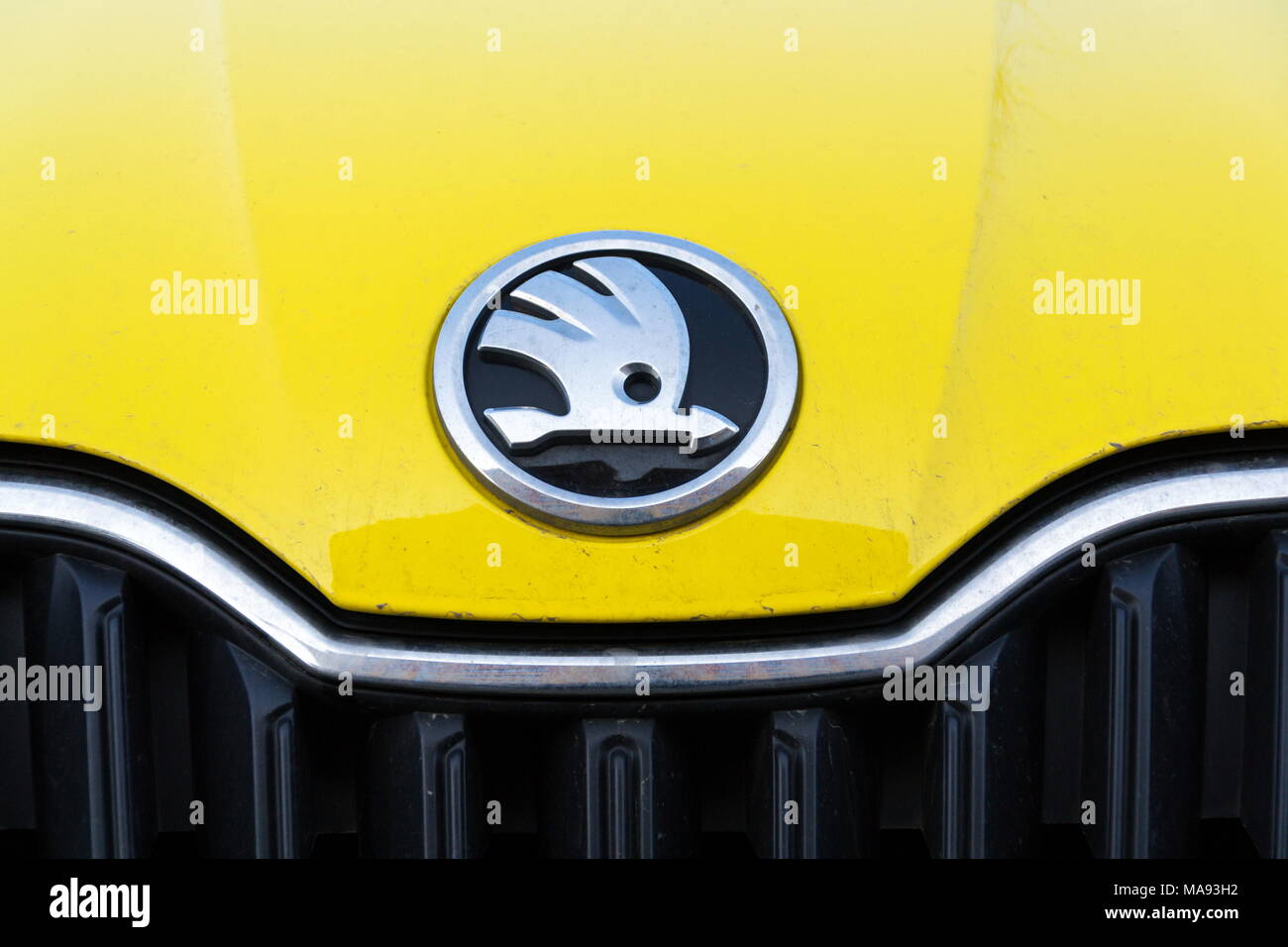 PRAGUE, CZECH REPUBLIC - MARCH 25 2018: Skoda Auto automobile manufacturer from Volkswagen Group company logo on yellow dirty car on March 25, 2018 in Stock Photo