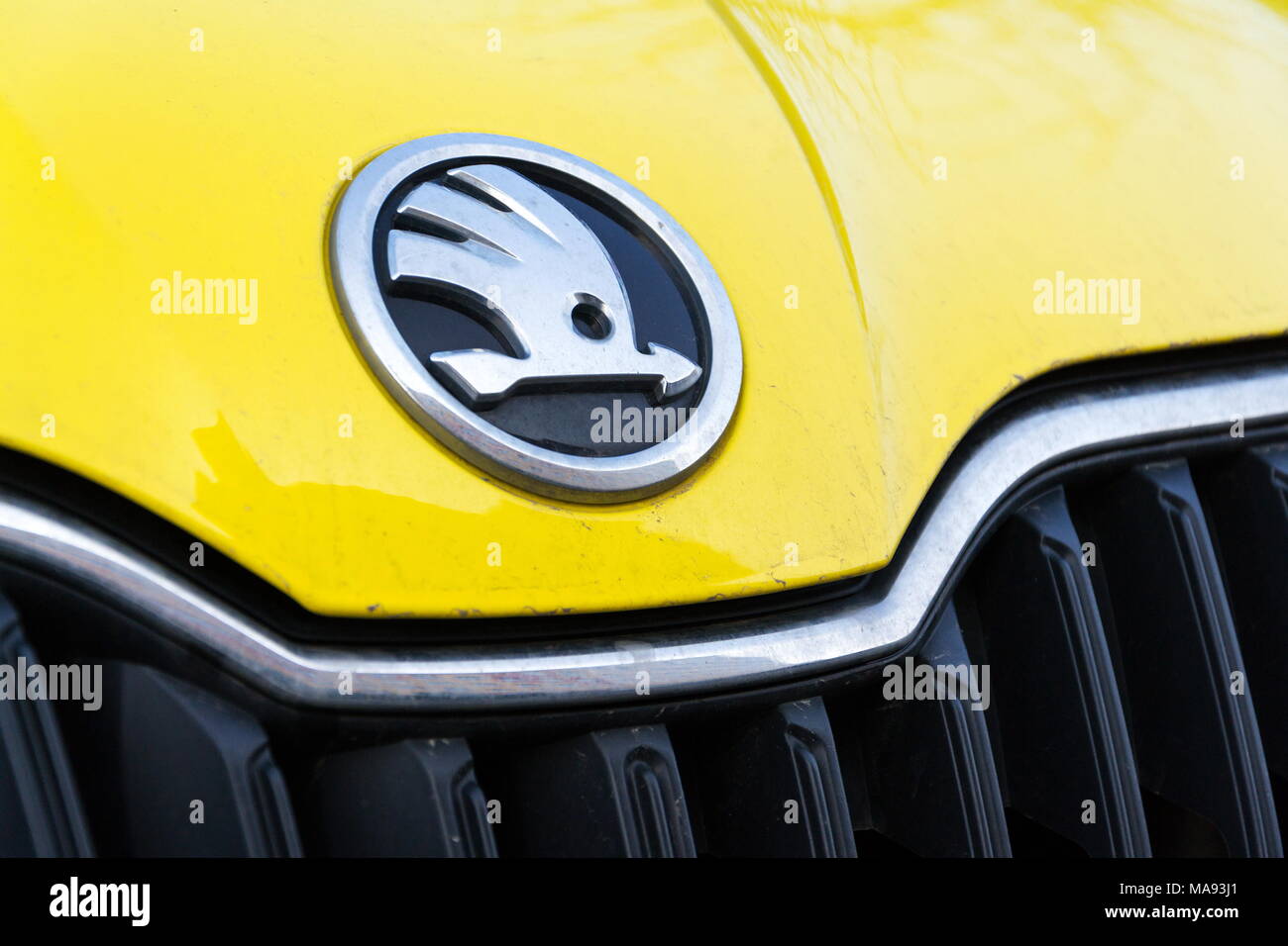 PRAGUE, CZECH REPUBLIC - MARCH 25 2018: Skoda Auto automobile manufacturer from Volkswagen Group company logo on yellow dirty car on March 25, 2018 in Stock Photo