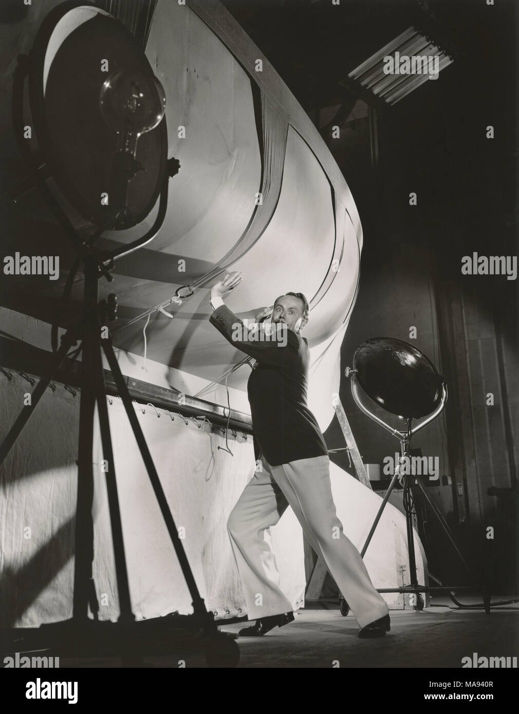 Charles Ruggles, Full-Length Publicity Portrait, On-set Attempting to Support a Stage Prop, Bert Longworth for Paramount Pictures, 1934 Stock Photo