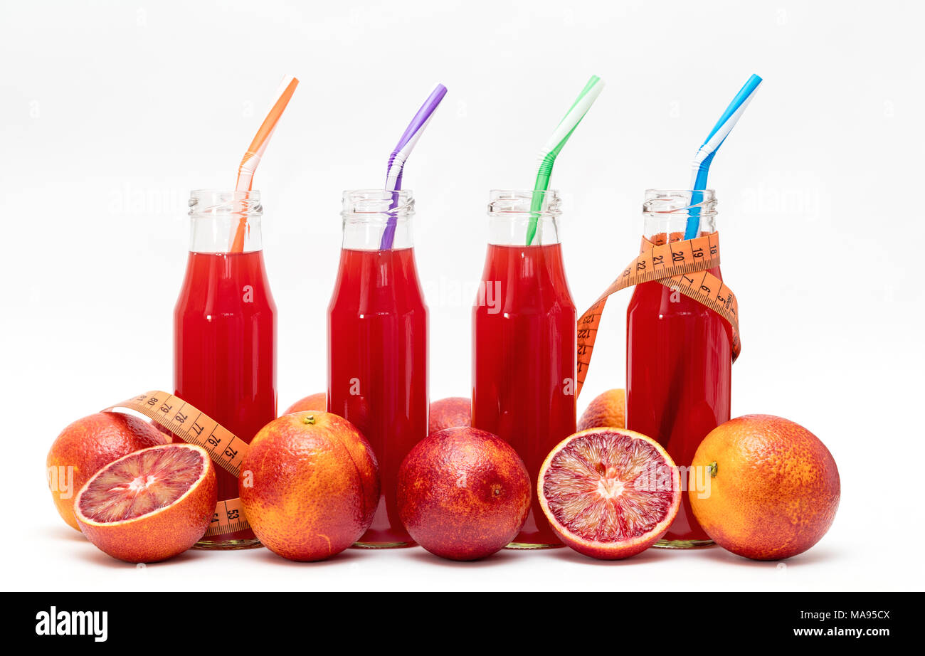 Glasses of fresh pressed blood orange fruit juice with tape measure