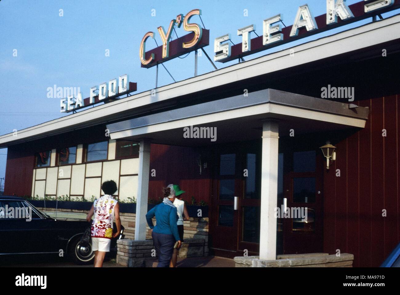 Tourists enter the classic CY's seafood restaurant in Moncton, Canada, 1970. () Stock Photo