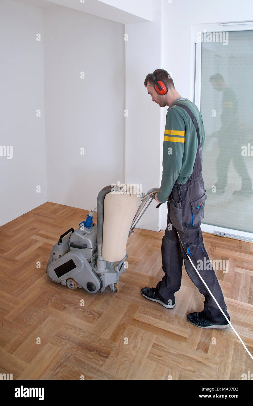Sanding Hardwood Floor With The Grinding Machine Repair In The