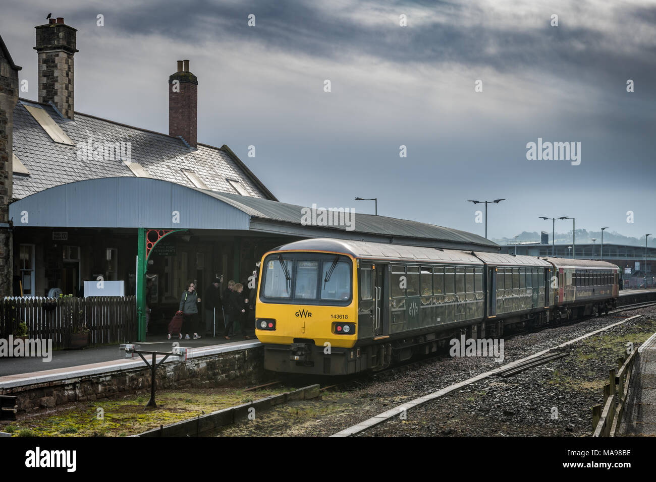 Commuters board the train about to depart from Barnstaple Railway Station on an overcast Good Friday in North Devon. Stock Photo