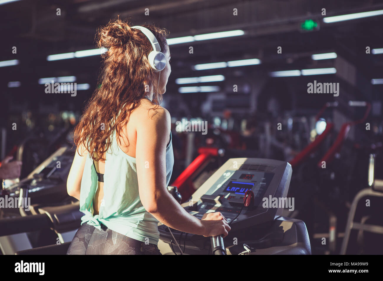 Back view. beautiful woman with lush curly hair in vest and elk