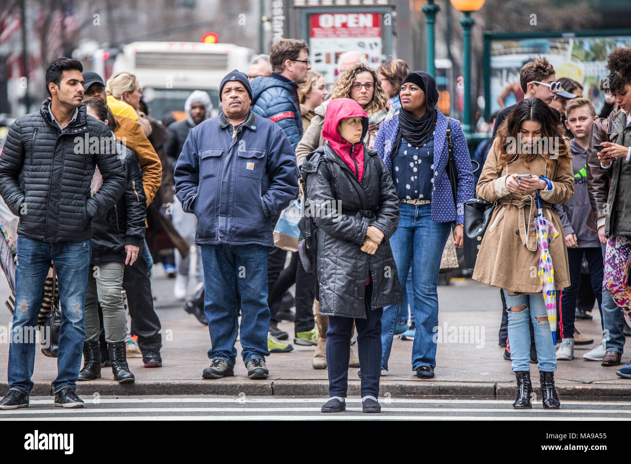 NEW YORK CITY - MARCH 29, 2018: Busy New York City street scene of diversity of pedestrian people crossing the street in Midtown Manhattan on 34th Str Stock Photo
