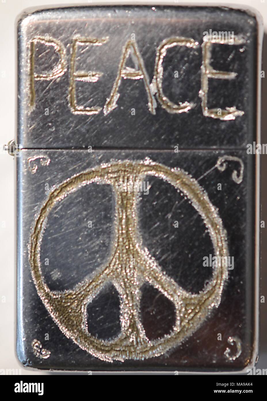 Close-up of metal Zippo lighter on which the owner has hand