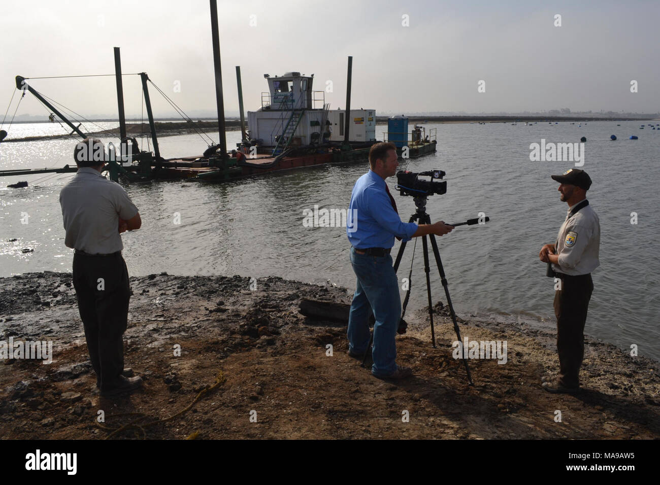 Channel 10 News story. Refuge Operations Specialist Kurt Roblek, and Project Leader for the San Diego NWR Complex Andy Yuen, get interviewed during the final breach of Pond 11, by Channel 10 News reporter, Joe Little. Stock Photo