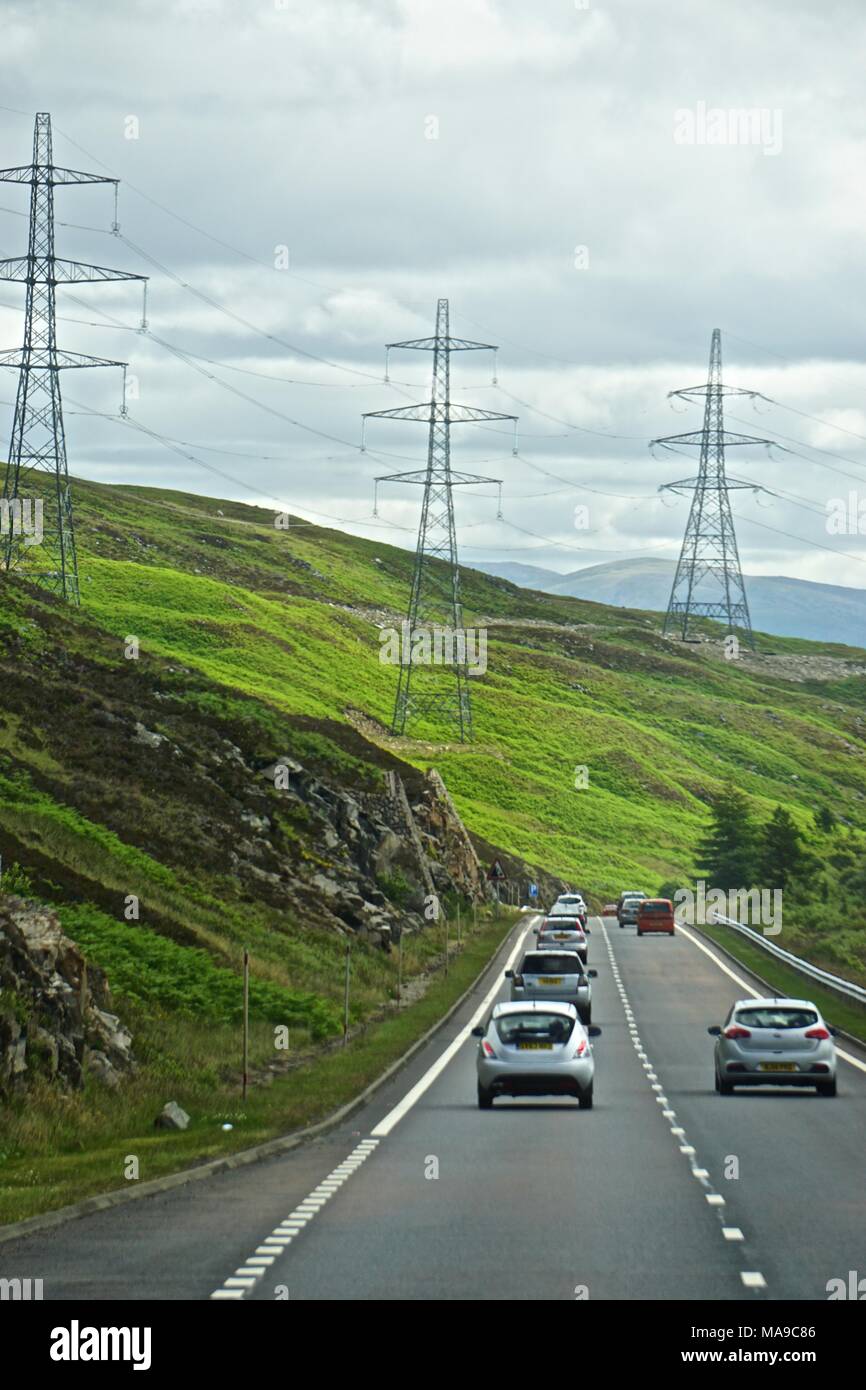 Power lines along a highway in the Highlands of Scotland Stock Photo
