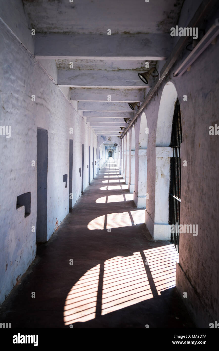 A long corridor in the old prison building with solitary confinement on its side. Stock Photo