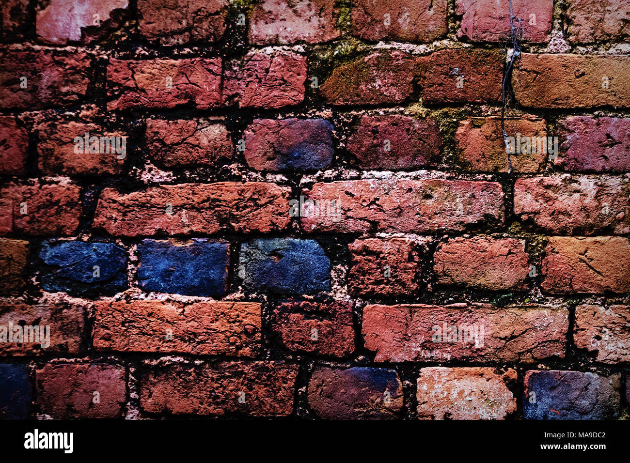 Old red brick wall texture. Brick wall painted in bright colors Stock Photo